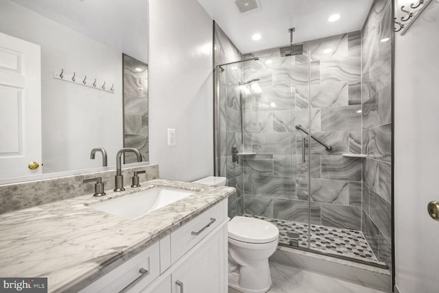 bathroom featuring walk in shower, vanity, and toilet