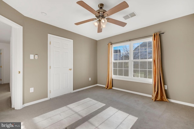 unfurnished bedroom with light colored carpet and ceiling fan