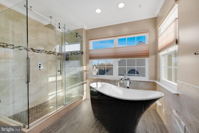 bathroom featuring ornamental molding, tile walls, and plus walk in shower