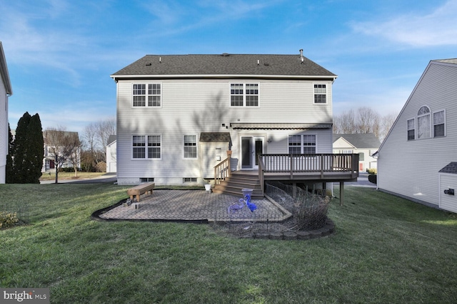 rear view of house with a wooden deck, a patio area, and a lawn