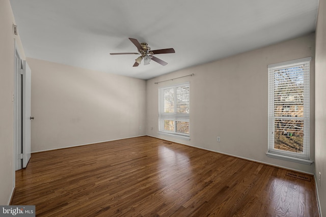 empty room featuring dark hardwood / wood-style floors and ceiling fan