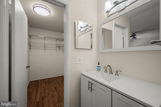 bathroom with hardwood / wood-style flooring, vanity, and ceiling fan