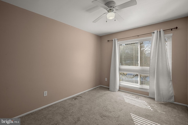 carpeted spare room with ceiling fan