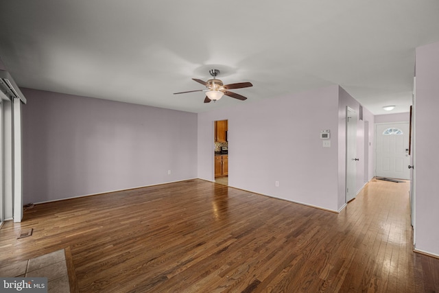 unfurnished living room with hardwood / wood-style floors and ceiling fan