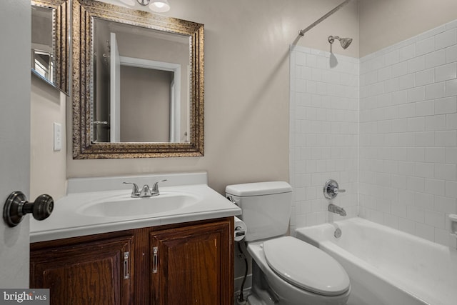 full bathroom with vanity, tiled shower / bath, and toilet