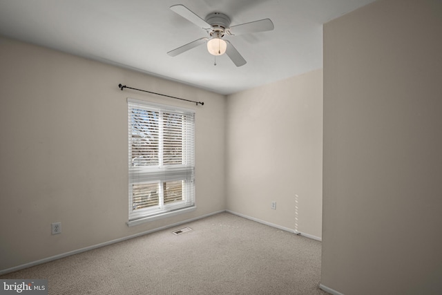 carpeted spare room featuring ceiling fan