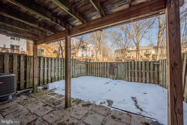 snow covered patio featuring central air condition unit