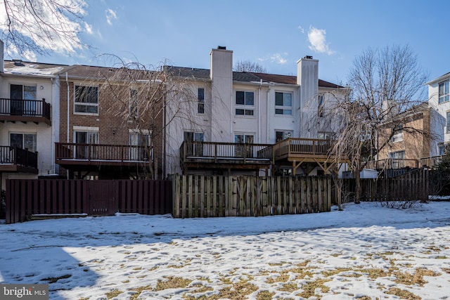 view of snow covered rear of property