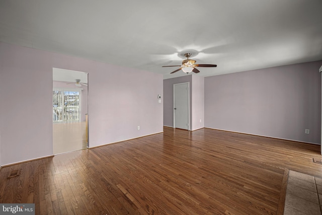 spare room with ceiling fan and dark hardwood / wood-style flooring