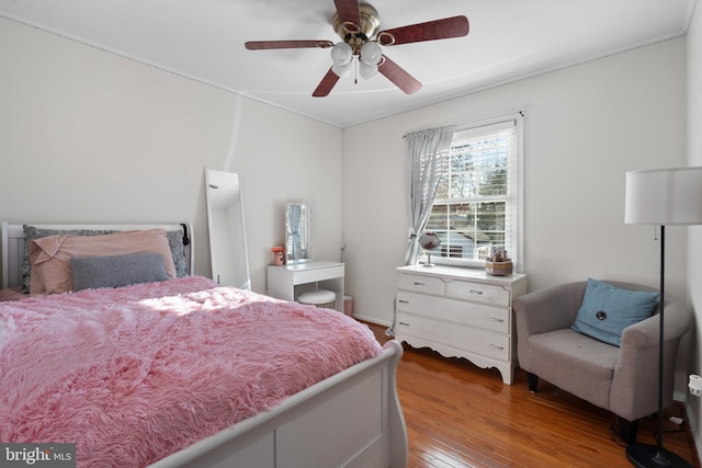 bedroom with hardwood / wood-style floors and ceiling fan