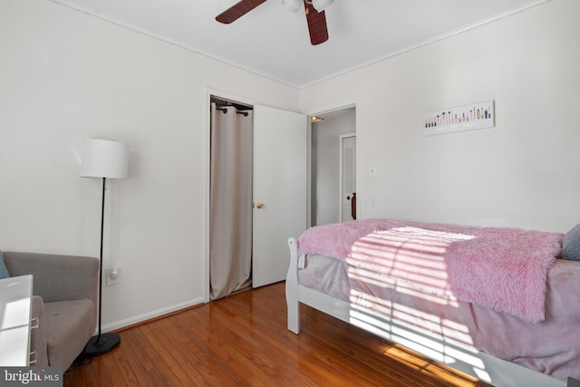 bedroom featuring ceiling fan, hardwood / wood-style floors, and a closet