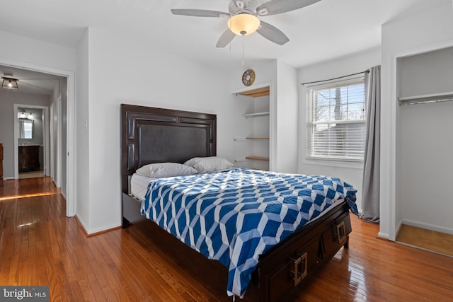 bedroom with ceiling fan and dark hardwood / wood-style flooring