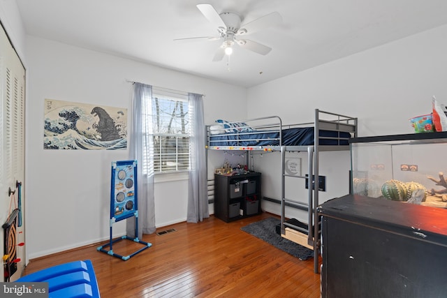 bedroom featuring ceiling fan, wood-type flooring, and a closet