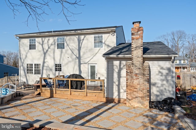 back of property featuring a deck and a patio area