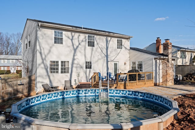 view of swimming pool with a deck