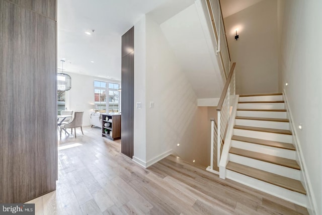 staircase with hardwood / wood-style flooring