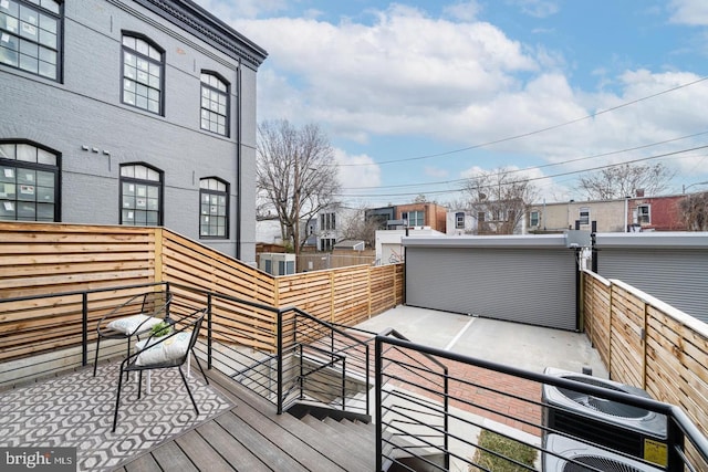 wooden terrace featuring central AC unit