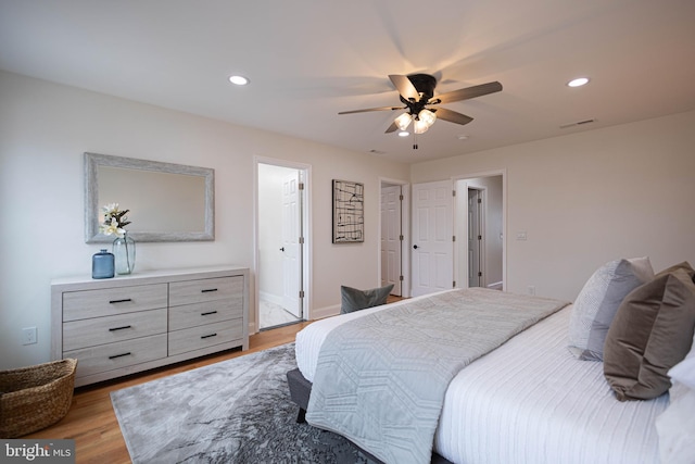 bedroom with light hardwood / wood-style flooring and ceiling fan