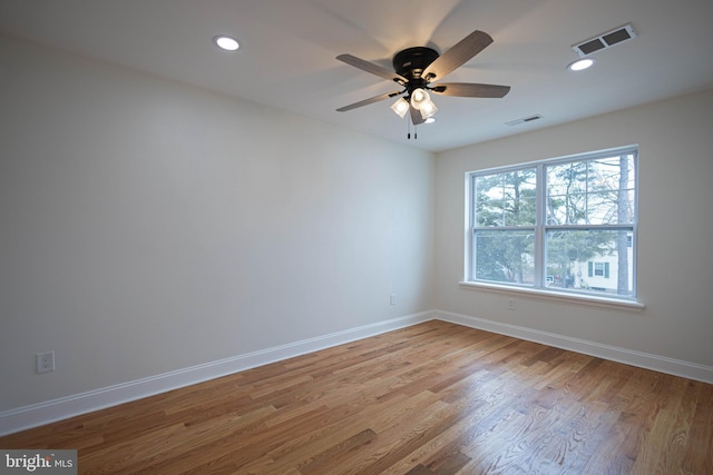 empty room with ceiling fan and light wood-type flooring