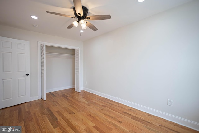 unfurnished bedroom with ceiling fan, a closet, and light hardwood / wood-style flooring