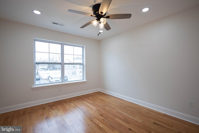 empty room with ceiling fan and light wood-type flooring