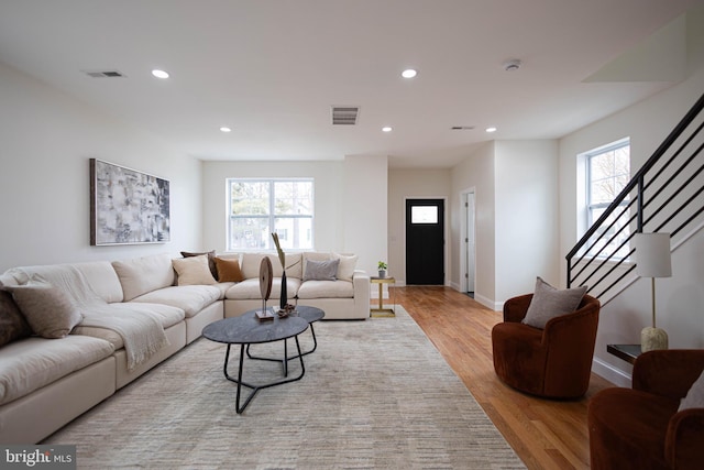 living room with a wealth of natural light and light hardwood / wood-style flooring