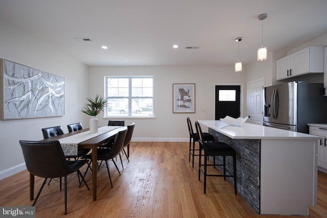 dining space with light hardwood / wood-style flooring