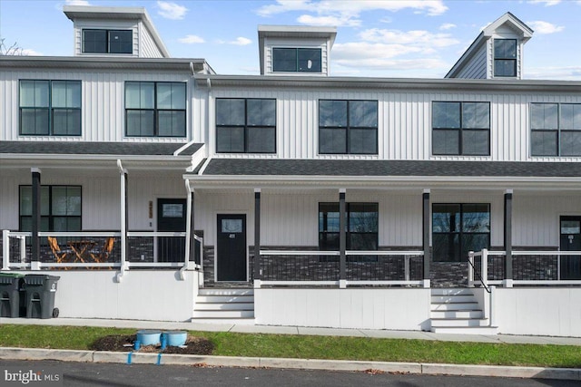 townhome / multi-family property featuring covered porch