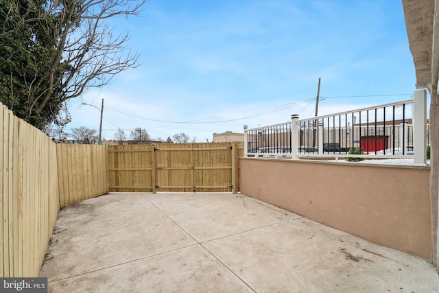 view of patio featuring a fenced backyard and a gate