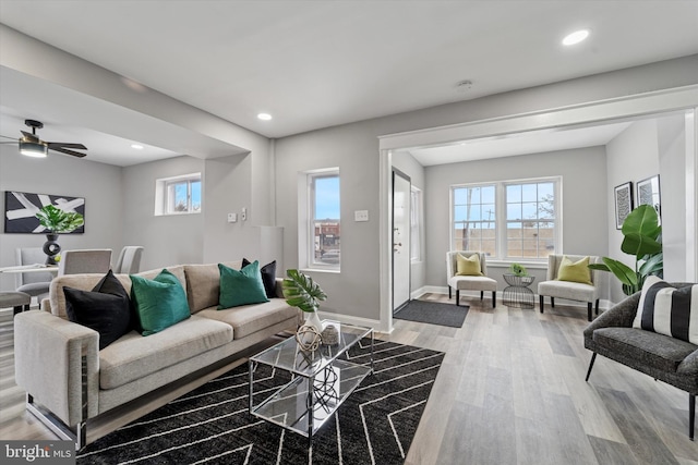 living area featuring ceiling fan, light wood finished floors, recessed lighting, and baseboards