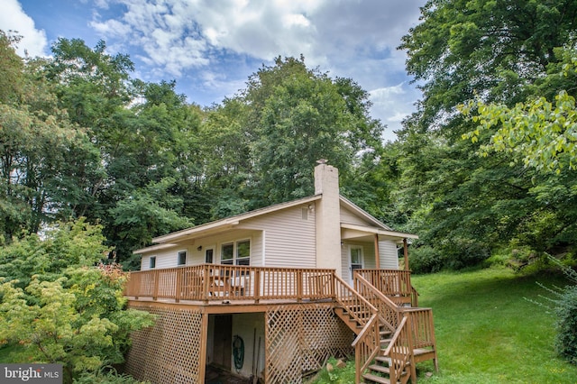 back of house with a yard and a deck