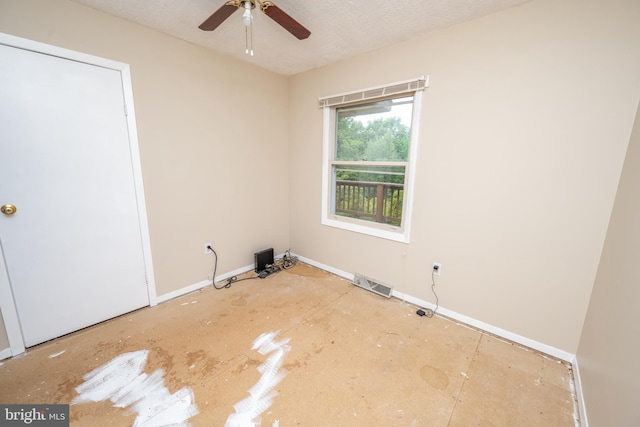 spare room with ceiling fan and a textured ceiling