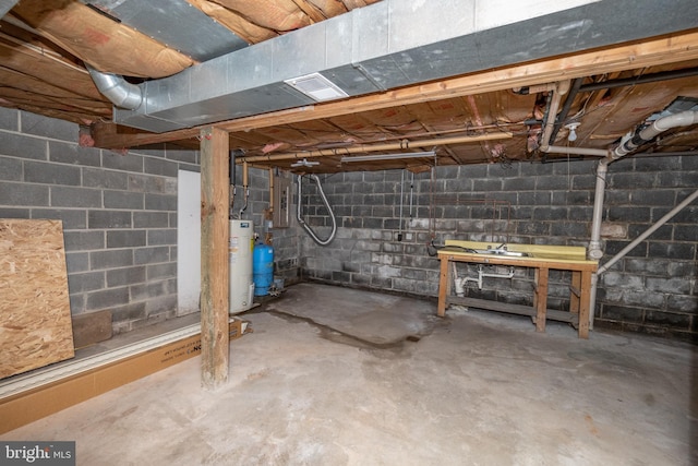 basement with electric panel and water heater