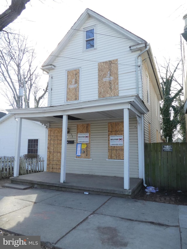 rear view of house featuring covered porch