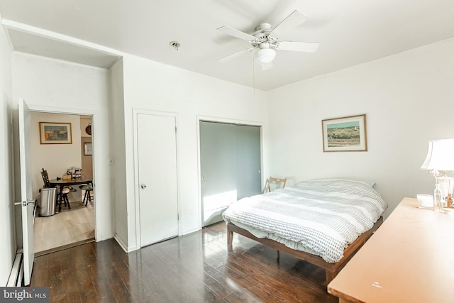 bedroom with dark hardwood / wood-style flooring and ceiling fan