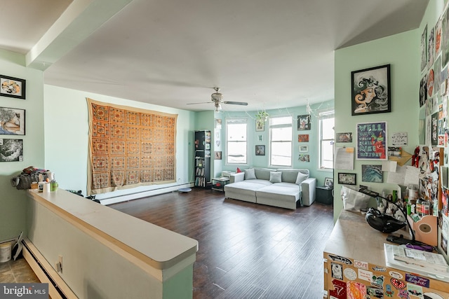 living room featuring ceiling fan, a baseboard heating unit, and dark hardwood / wood-style flooring