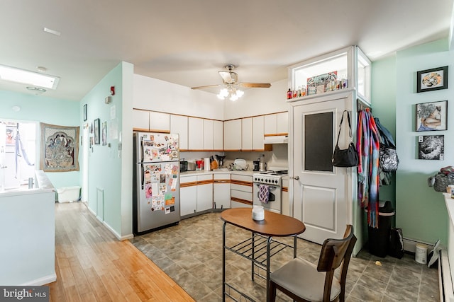 kitchen with white cabinetry, light hardwood / wood-style flooring, stainless steel refrigerator, electric stove, and ceiling fan