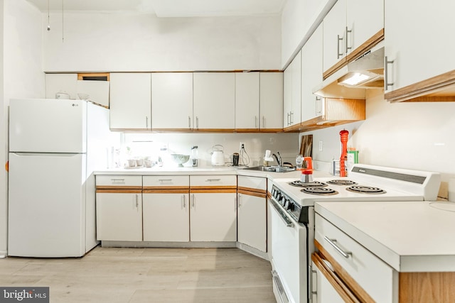 kitchen featuring white cabinetry, sink, white appliances, and light hardwood / wood-style flooring