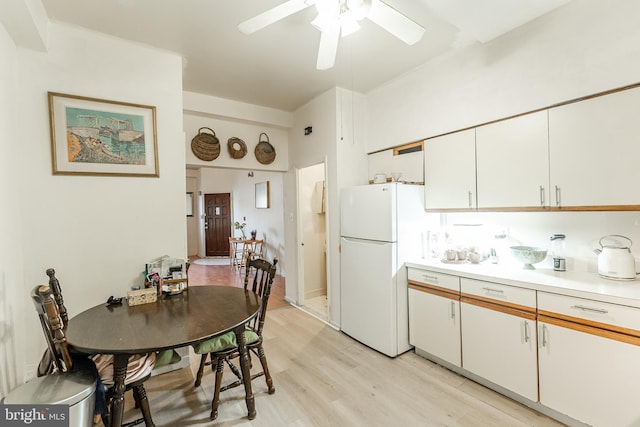 kitchen with ceiling fan, light wood-type flooring, white cabinets, and white fridge