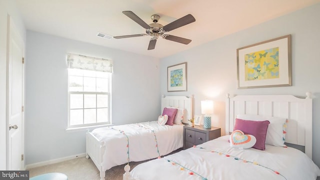 bedroom with ceiling fan and light colored carpet