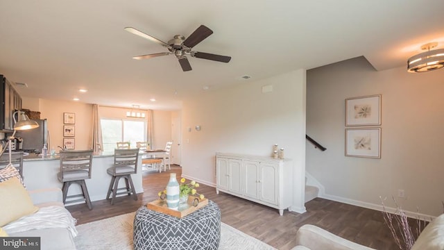 living room featuring dark hardwood / wood-style floors and ceiling fan