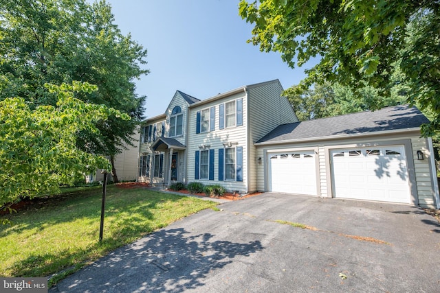 view of front of home with a garage and a front lawn