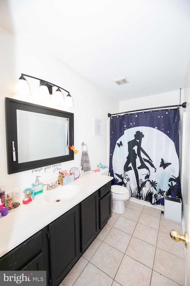 bathroom with a shower with curtain, vanity, tile patterned floors, and toilet