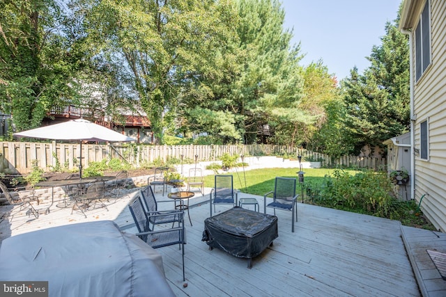 wooden deck with area for grilling and a lawn