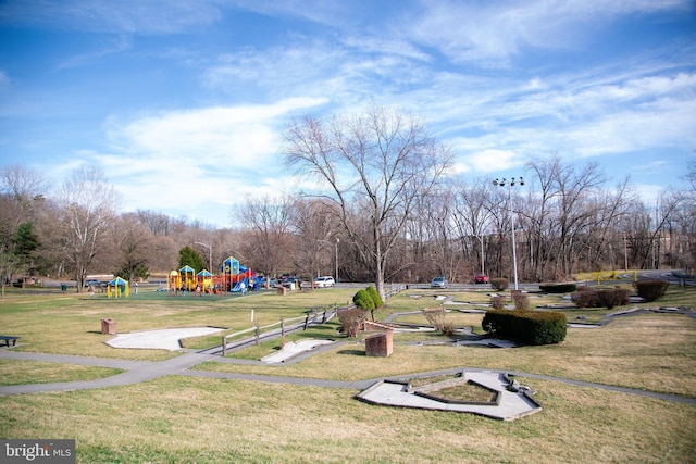 view of property's community with a yard and a playground