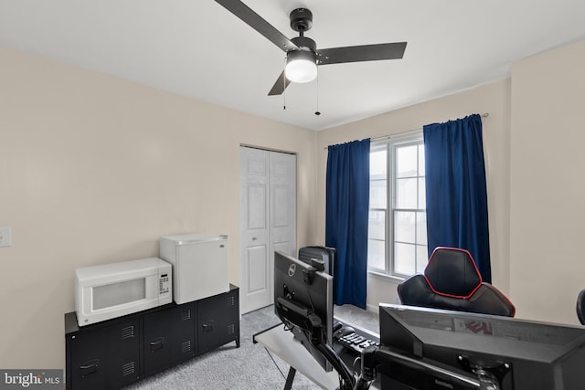 office area featuring light colored carpet and ceiling fan