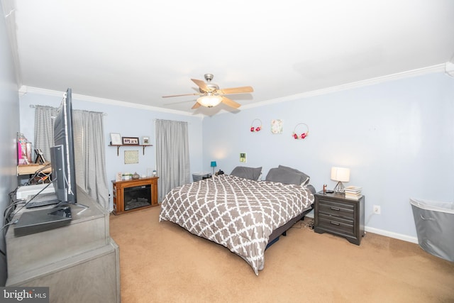 bedroom with crown molding, ceiling fan, and carpet flooring