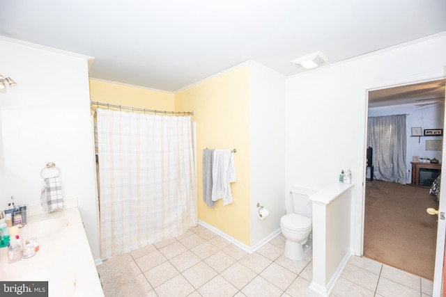 bathroom with crown molding, vanity, toilet, and tile patterned flooring