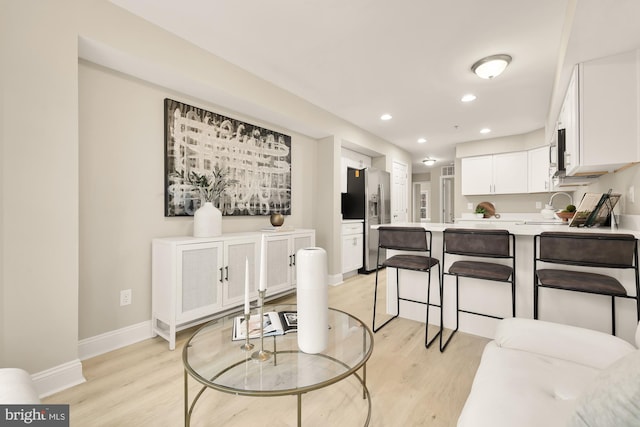 dining area featuring baseboards, recessed lighting, and light wood-style floors