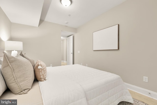 bedroom featuring baseboards and light wood-style floors